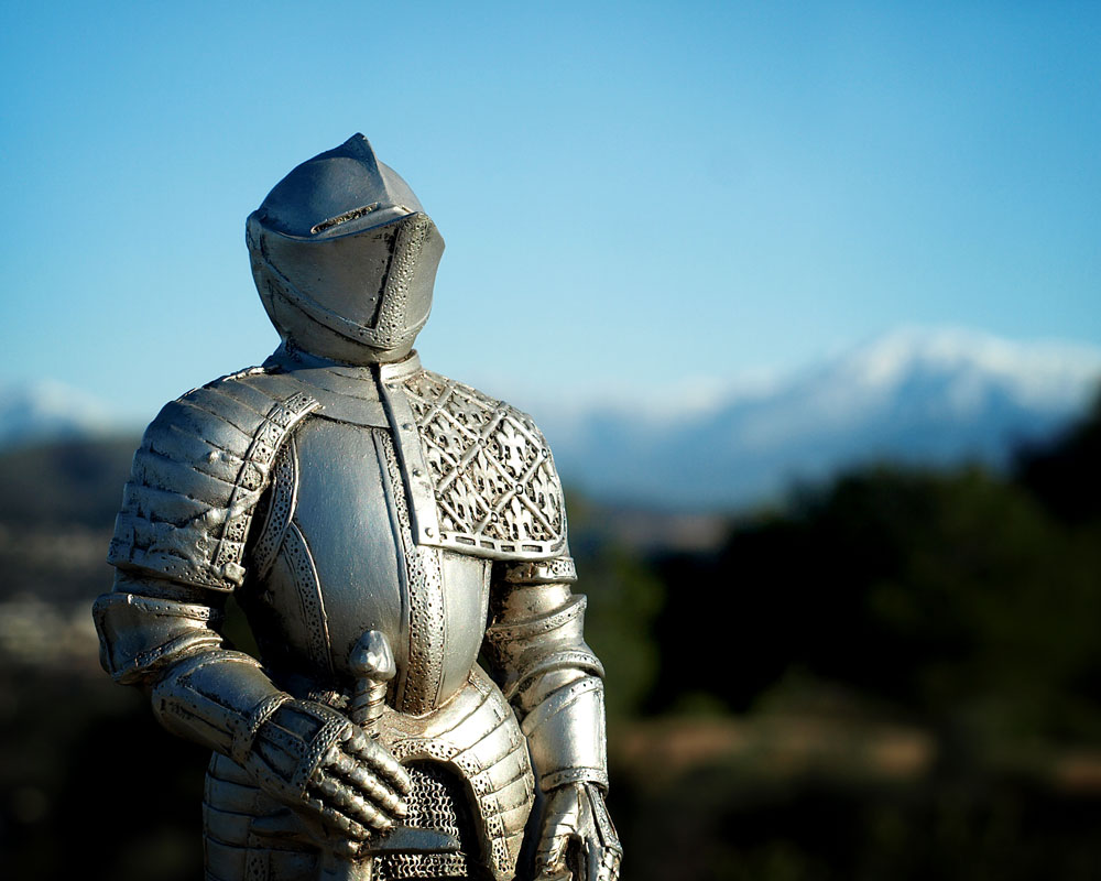 knight figurine with mountains in background