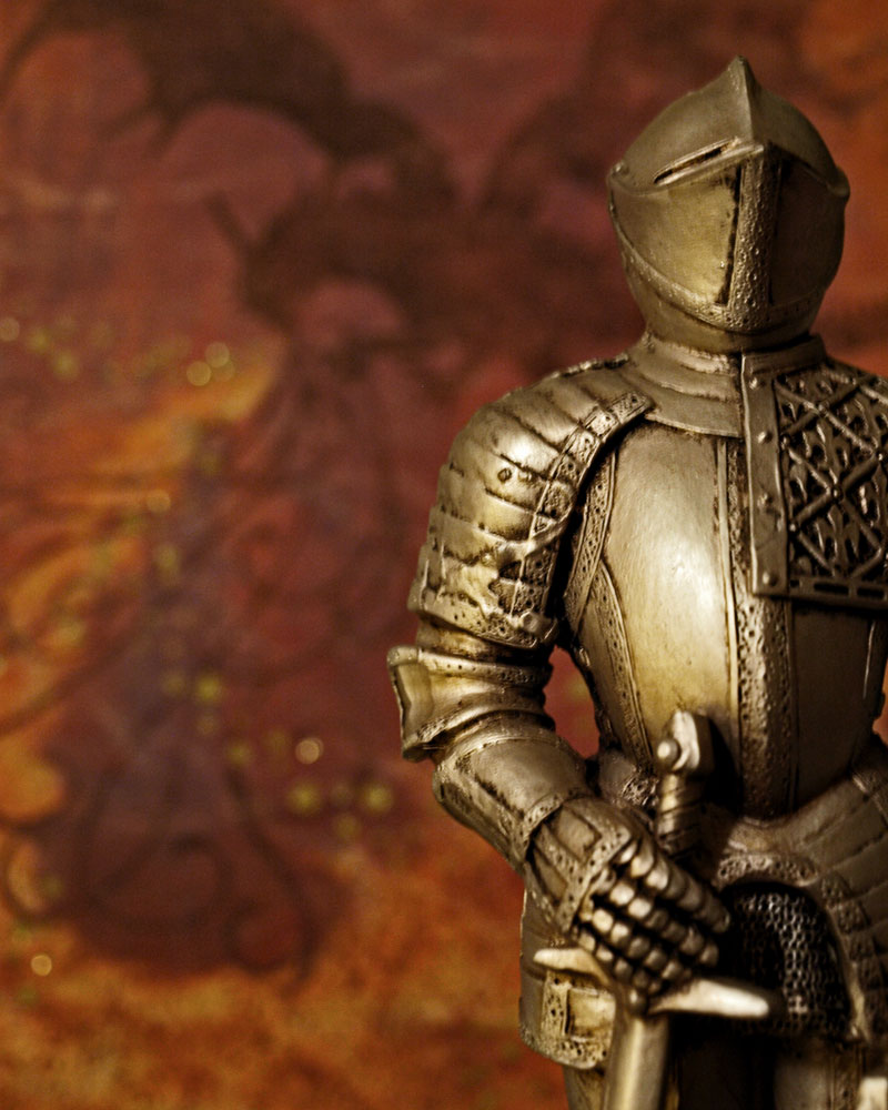 knight figurine with illustrated dragon