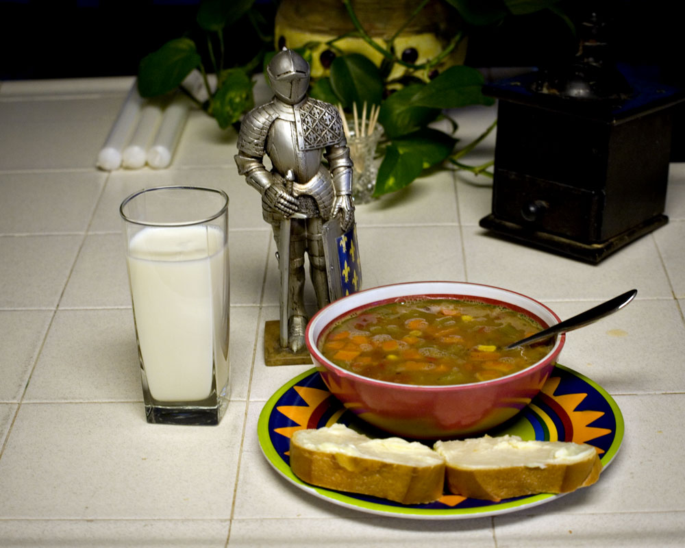 knight figure on counter with soup bowl and glass of milk