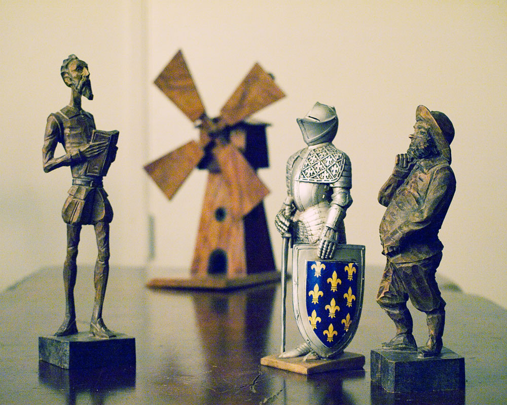 kiight figure with don quixote and pancho sanza figure and a windmill in background