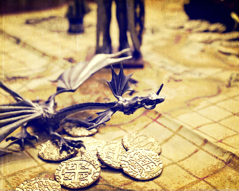 knight figure's feet on map with dragon figure and dubloons