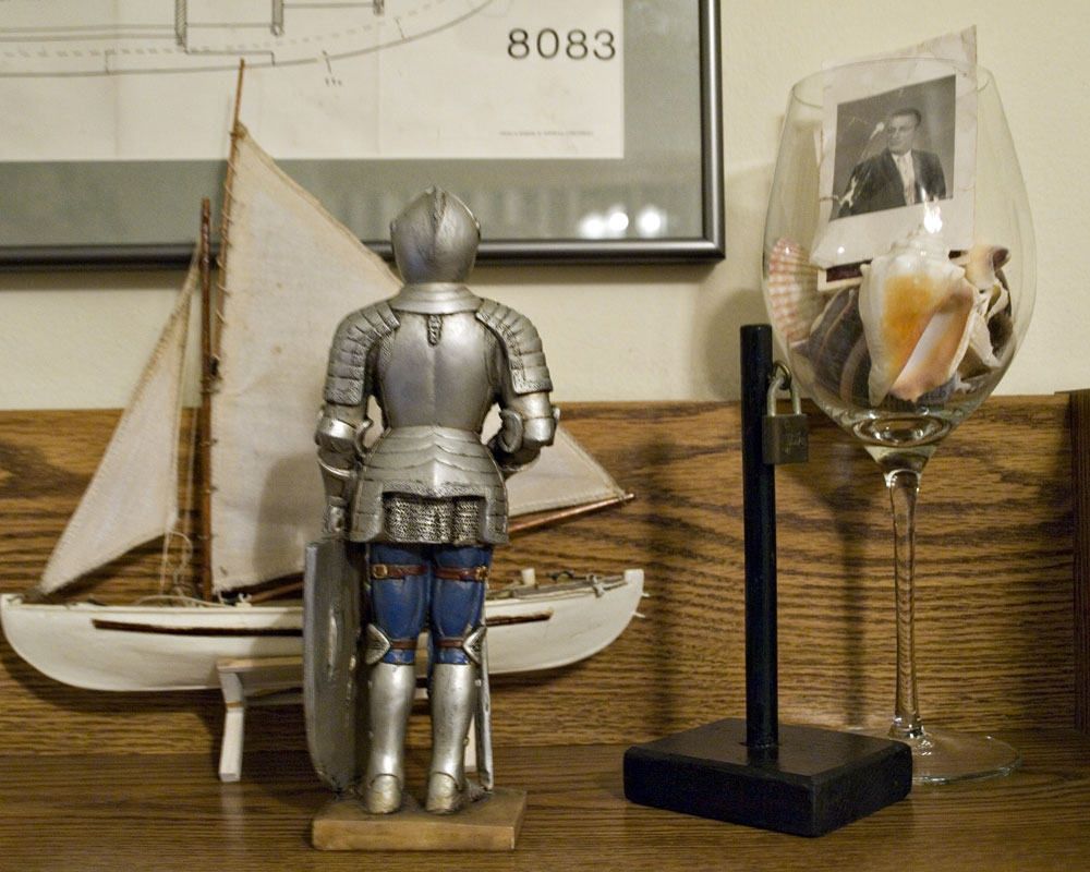knight figure on shelf with toy boy