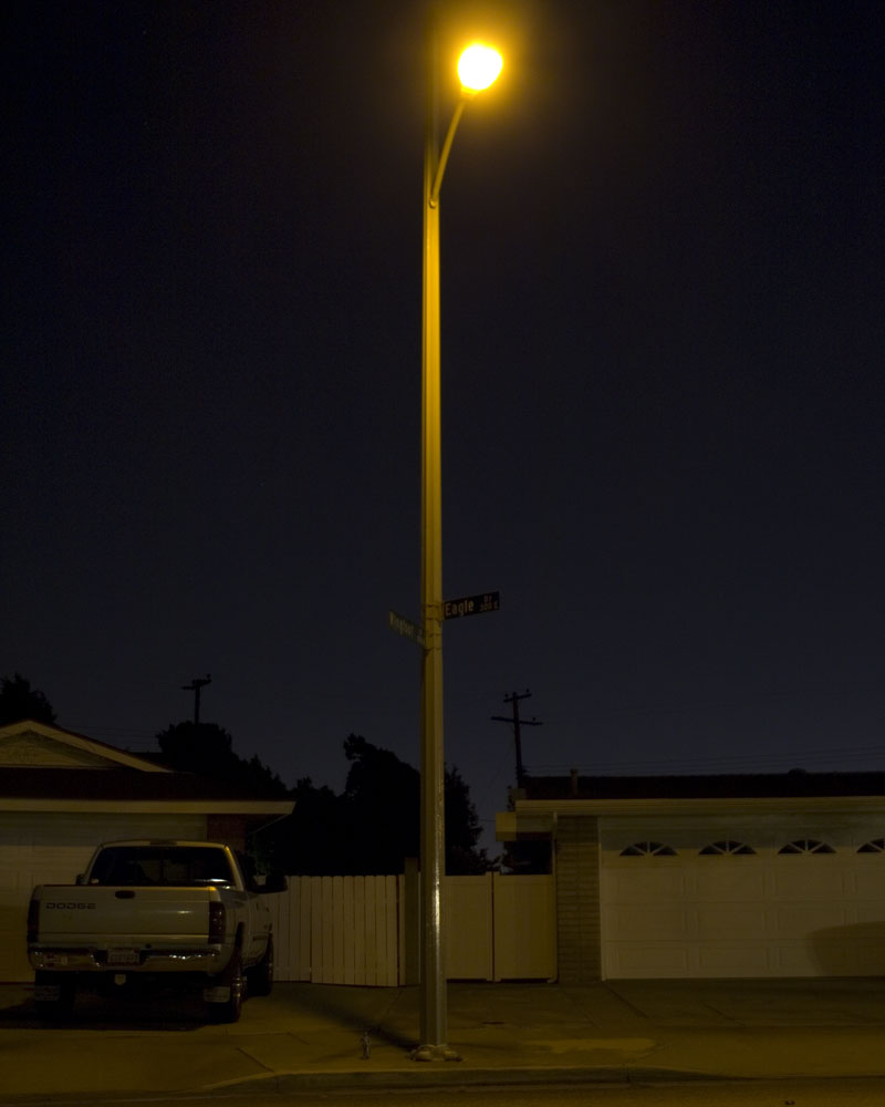 knight figure standing under lightpole