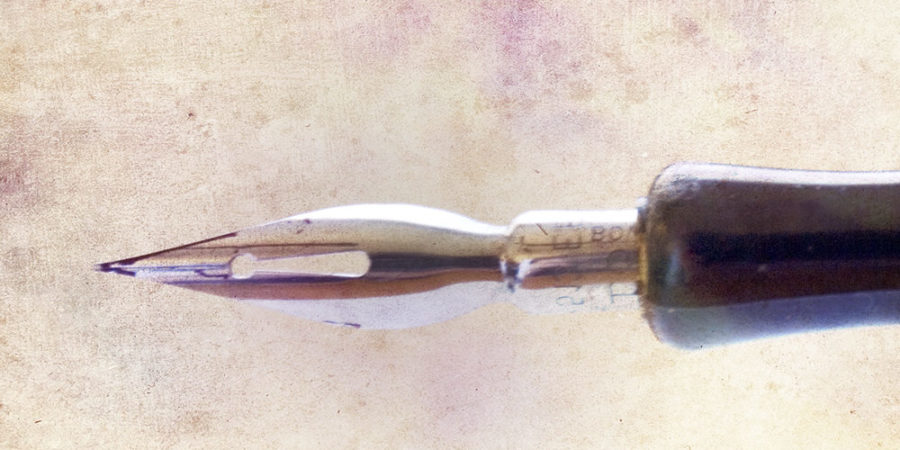 dip pen against watercolor background