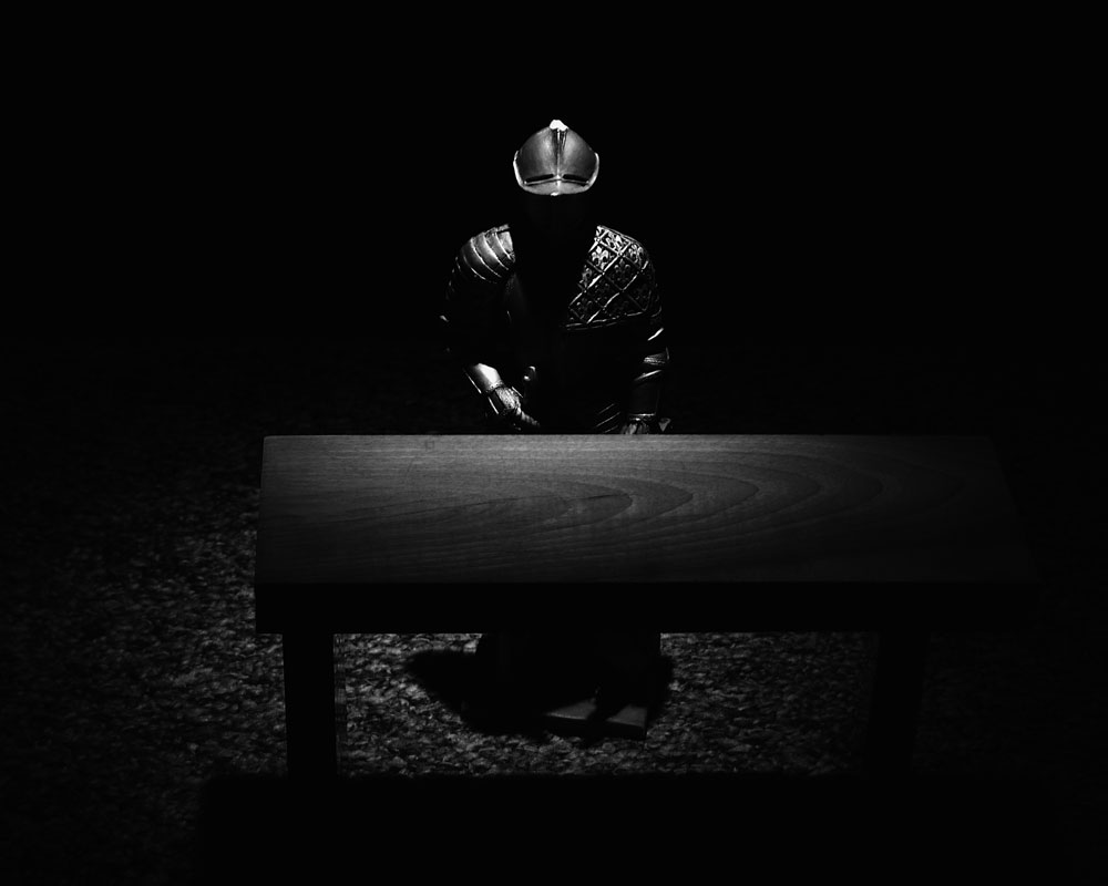 knight behind table in black and white