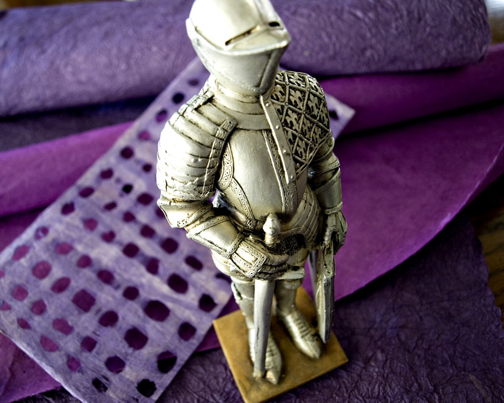 knight posing with purple paper