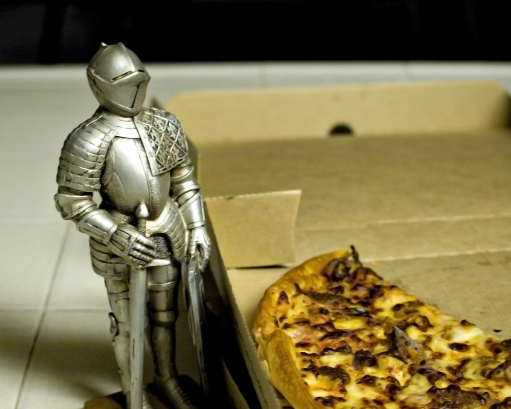 knight figure standing by pizza
