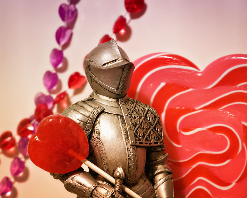 knight figure with red lollipop against heart background