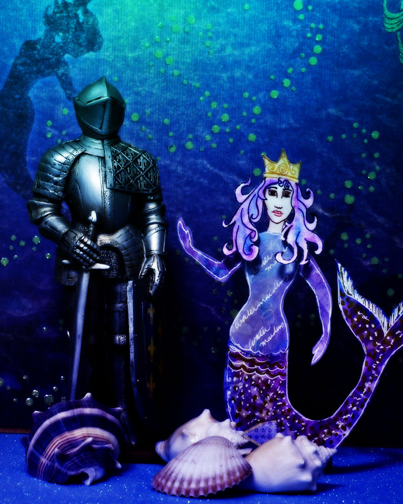 knight figure in paper "ocean" with mermaid cutout