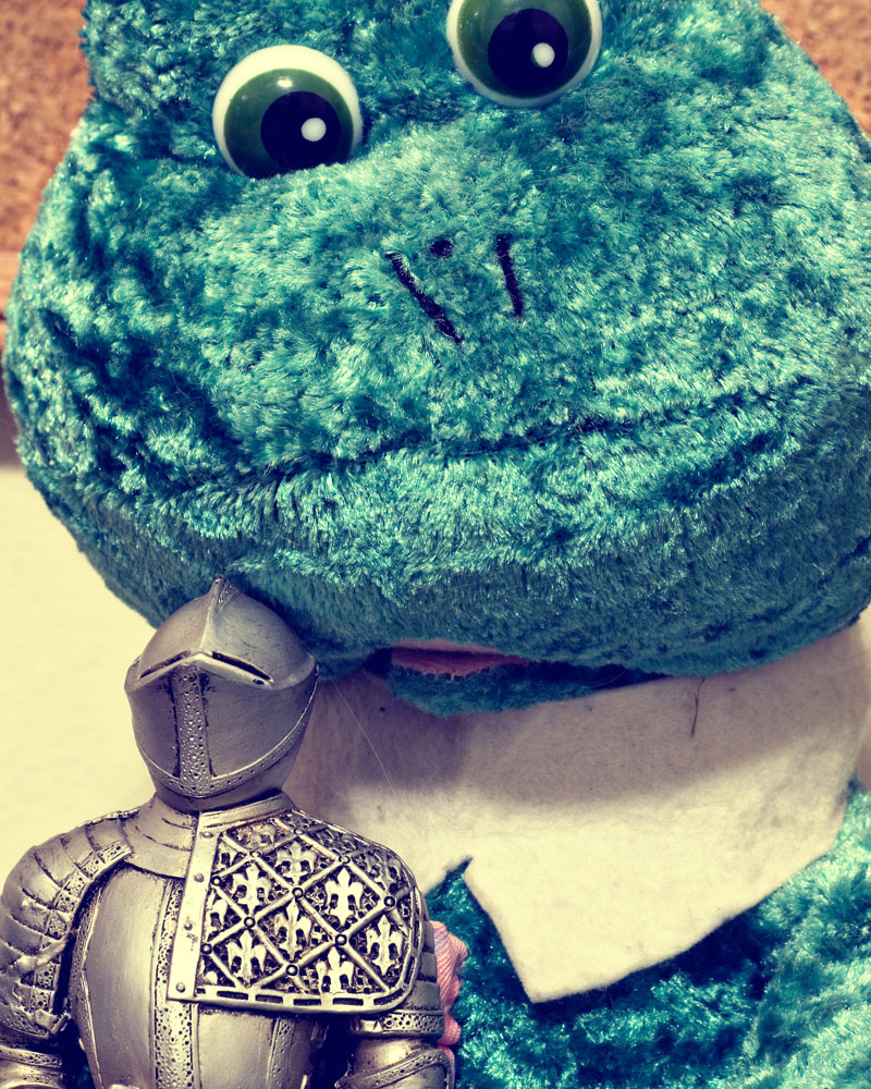 knight figure posing with large stuffed frog