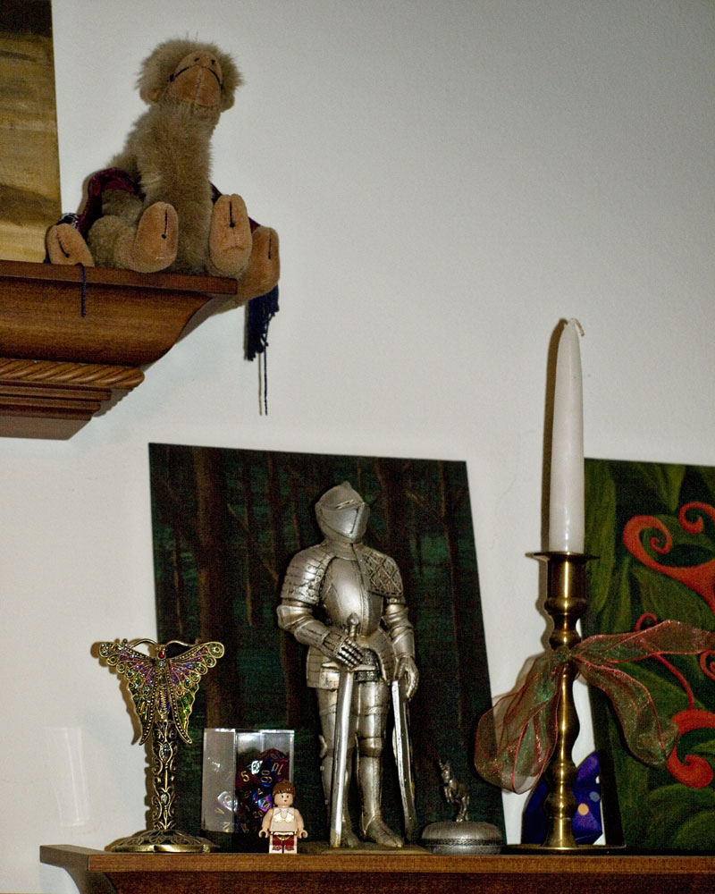 knight figure standing on shelf with various items
