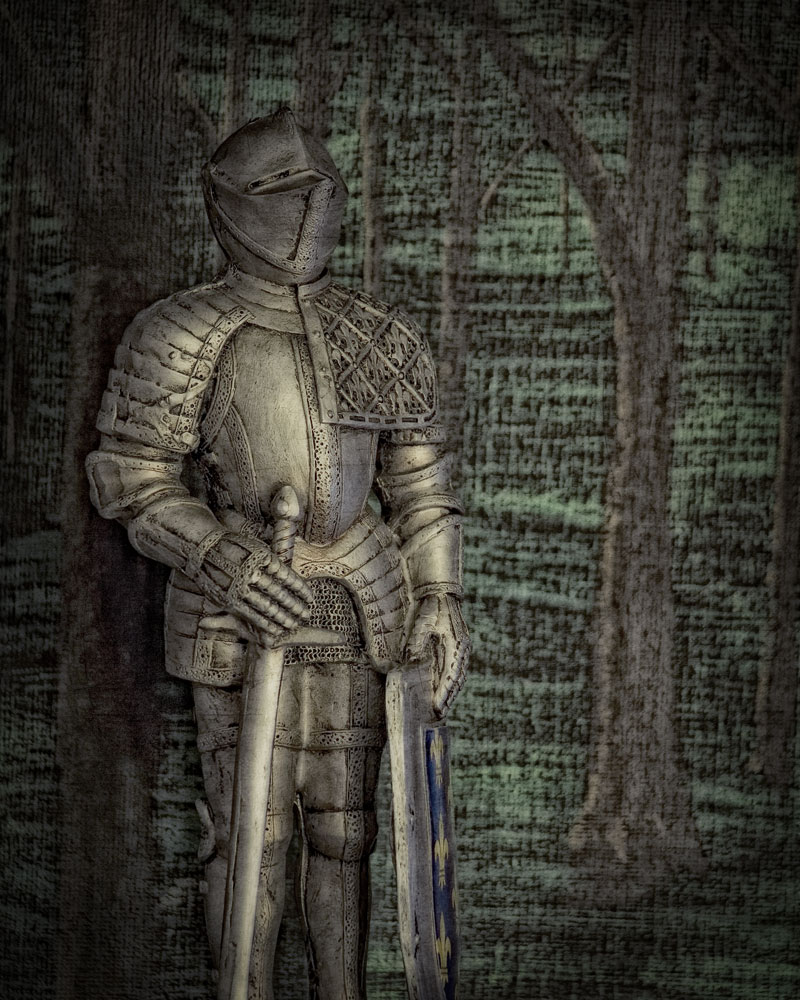 knight figure standing in front of painting of forest