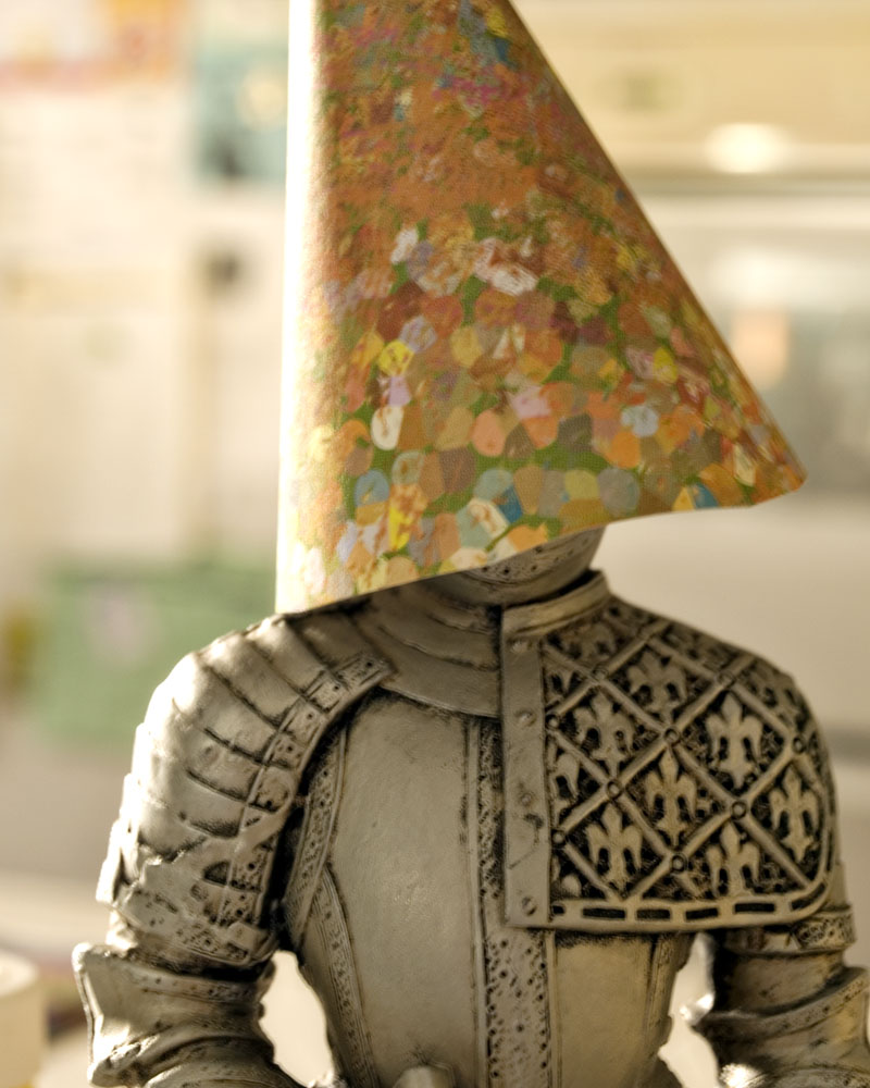 knight figure with paper cone over head