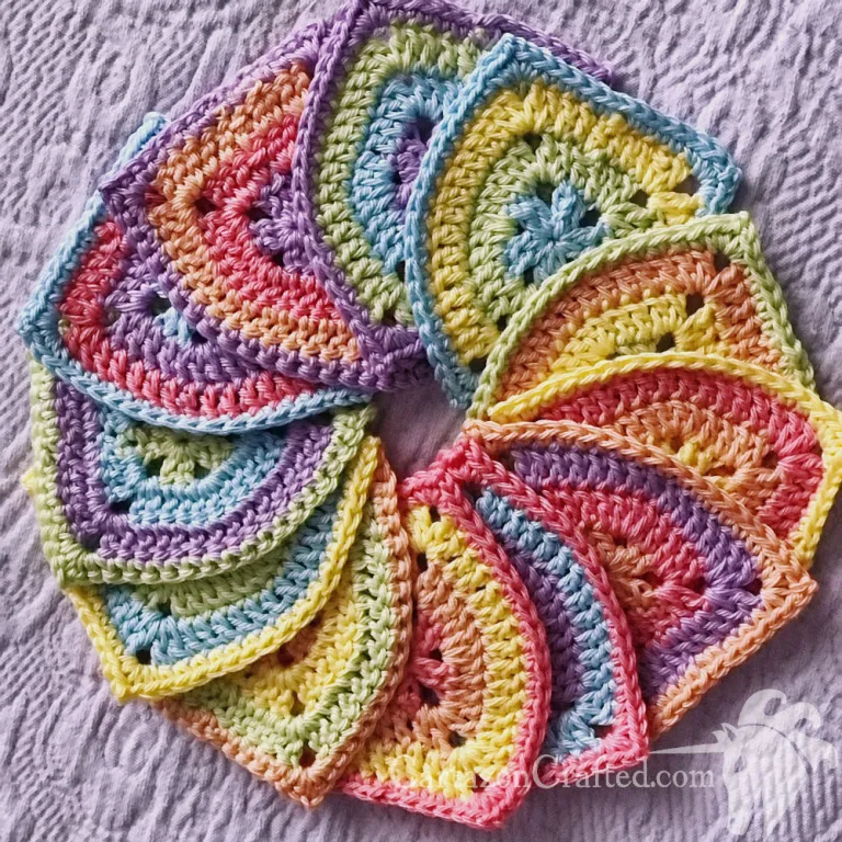 circle of crocheted pennants in pastel rainbow colors