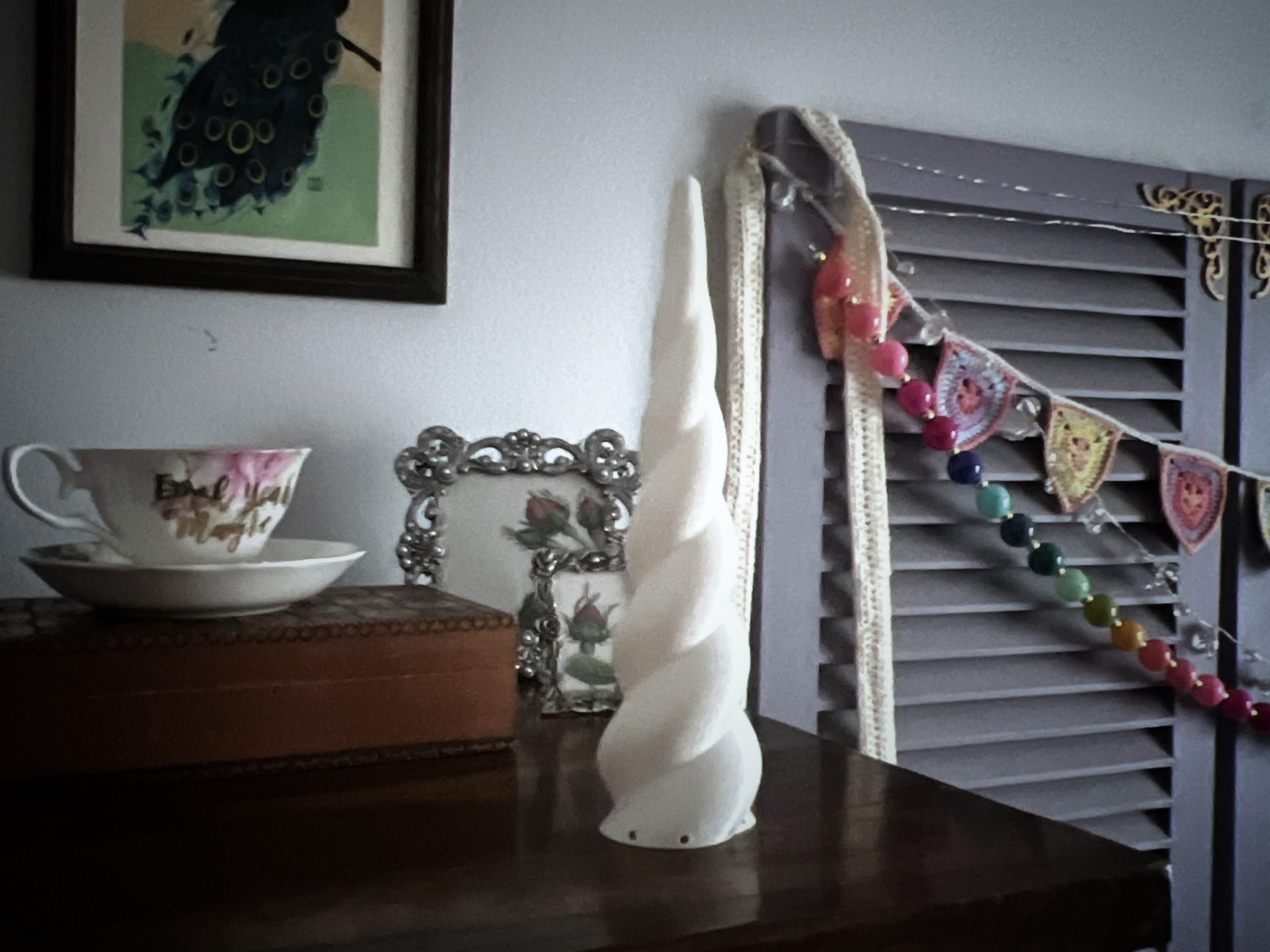 a plastic unicorn horn sitting on top of a dresser