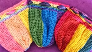 three rainbow dice bags