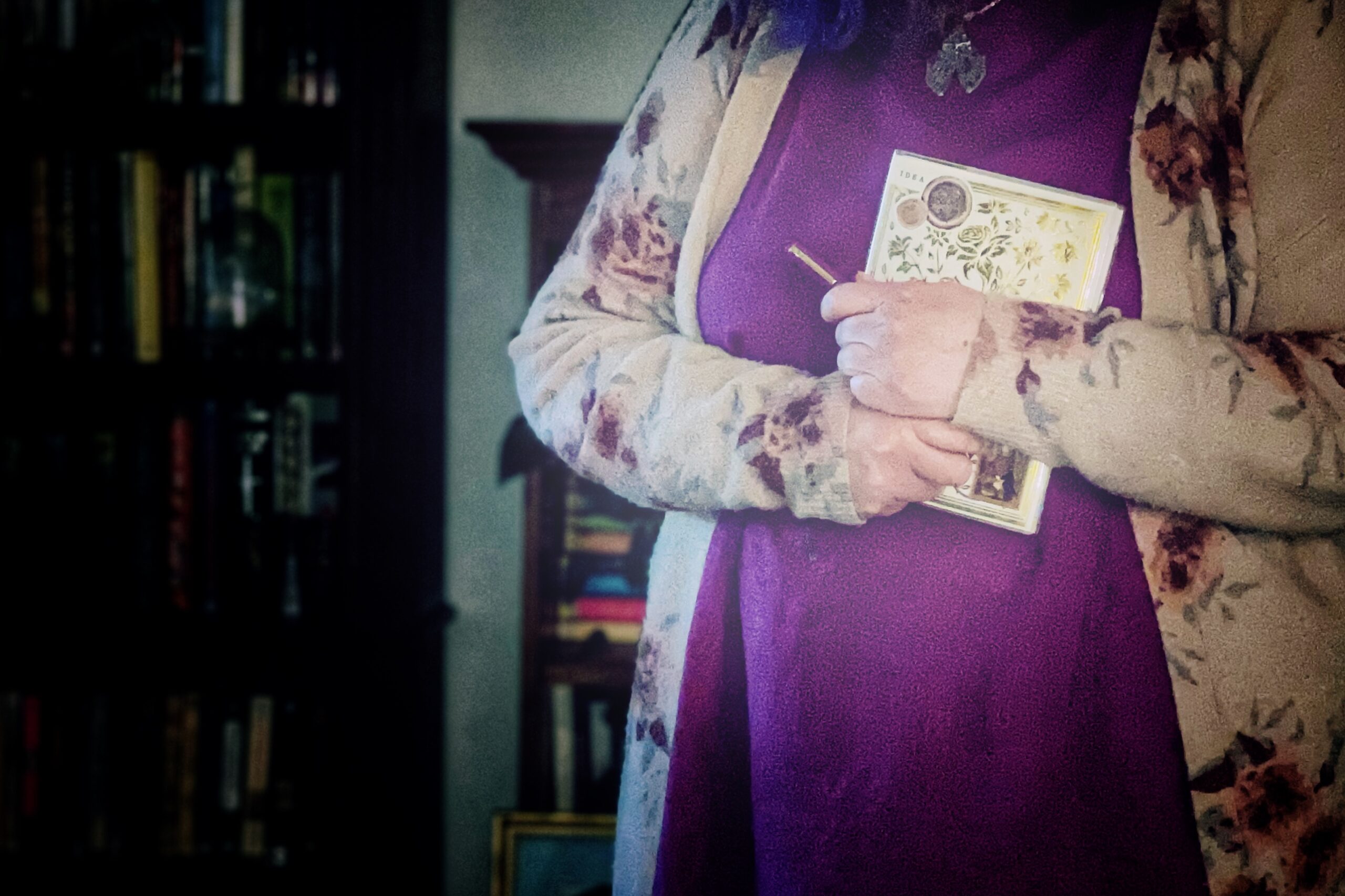 woman holding a notebook and pen